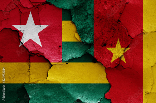 flags of Togo and Cameroon painted on cracked wall