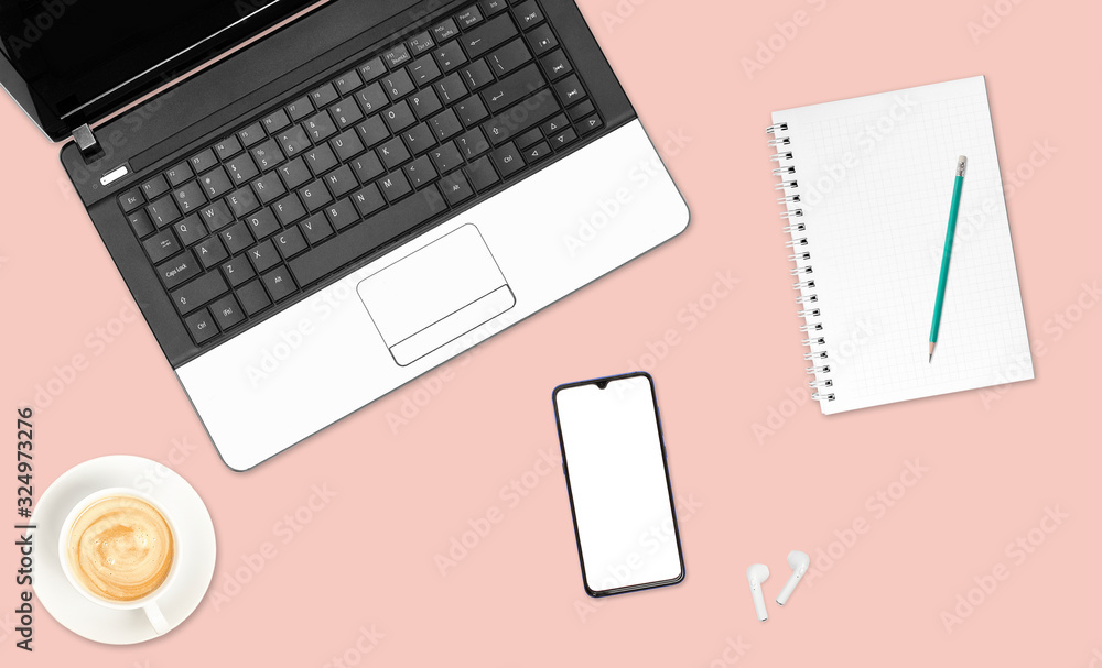 Top view office table desk, mobile phone, laptop, notebook, pencil, wireless headphones, and coffee cups on a white background. Top view office table desk, mobile phone, laptop, notebook, pencil, wireless headphones, and coffee cups on a white background.