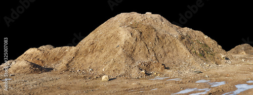 A large pile of construction sand with traces of tractor wheels. Isolated on white outdoor shot isolated black