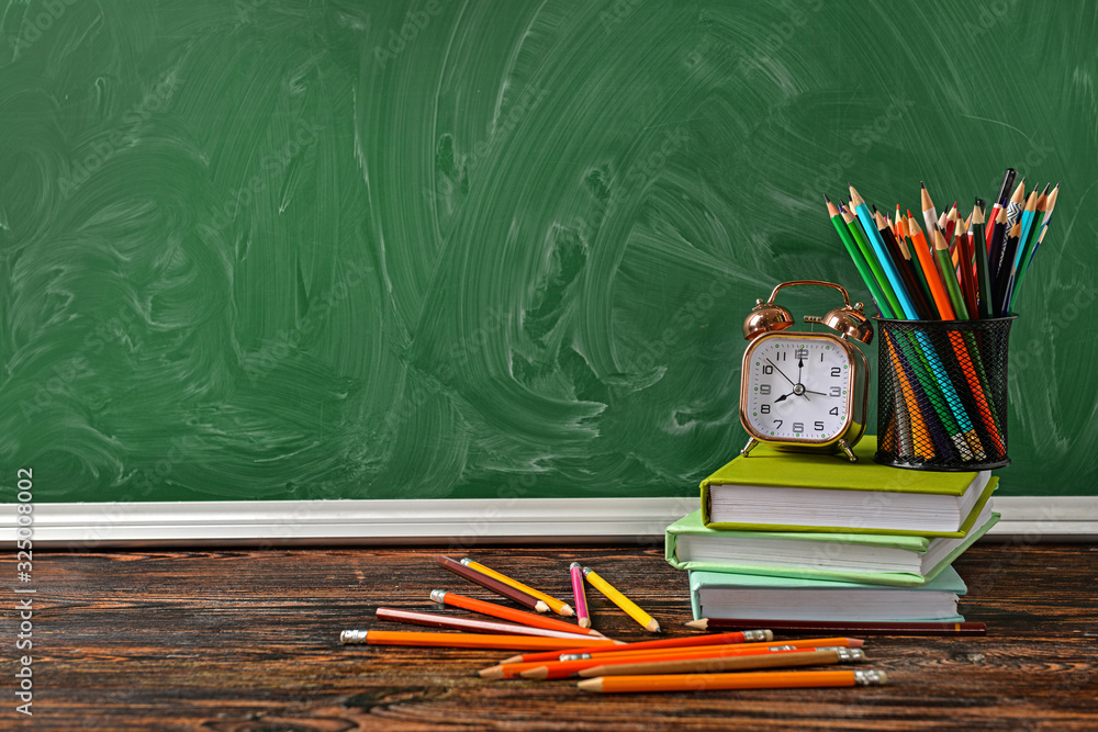 Set of school supplies and clock on table. Time to study Set of school supplies and clock on table. Time to study