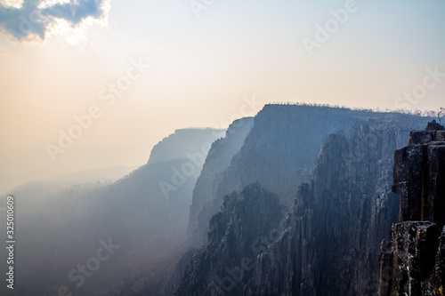 A smoke filled valley at devils gullet in tasmania. © Liam