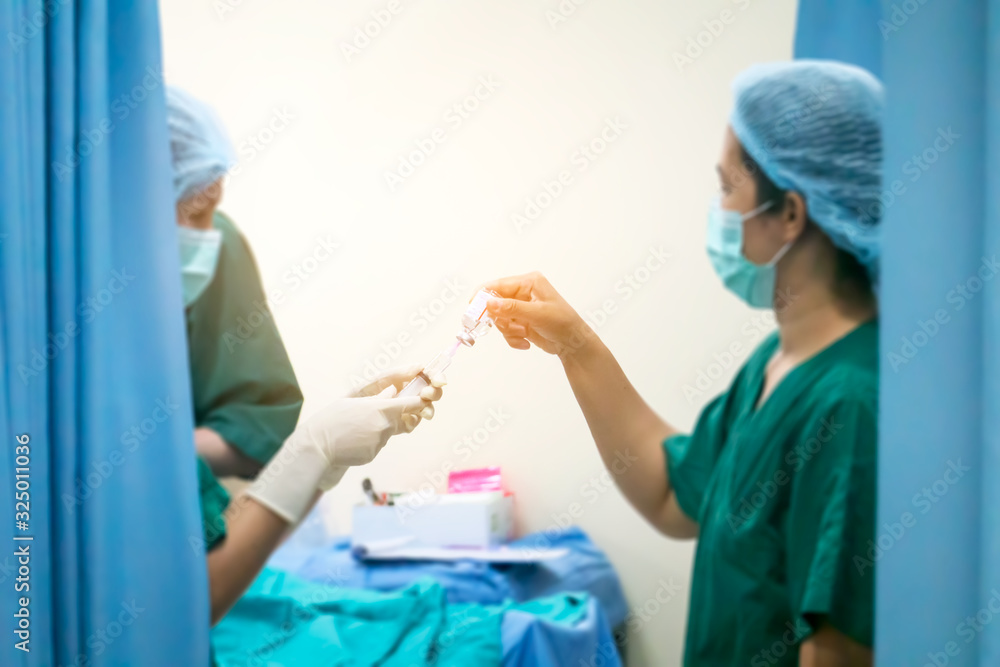 Blurred image of team of surgeons performing surgery in hospital sterile environment, or Group of surgeons in operating room with surgery equipment. Defocused Background Blurred image of team of surgeons performing surgery in hospital sterile environment, or Group of surgeons in operating room with surgery equipment. Defocused Background