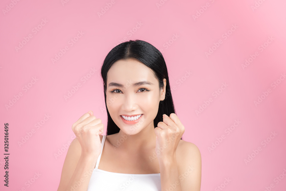 Excited beautiful young woman posing with perfect skin over pink background. Excited beautiful young woman posing with perfect skin over pink background.