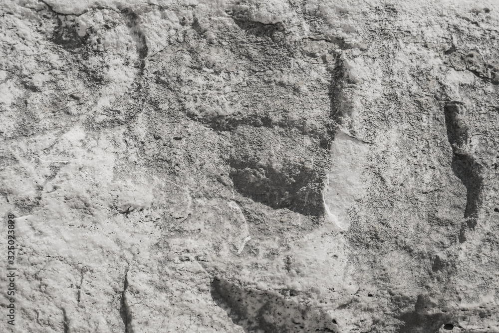 Texture of a stone Granite slab. Rough gray granite. Textured stone background. Stone slab of the ruins of an ancient city.