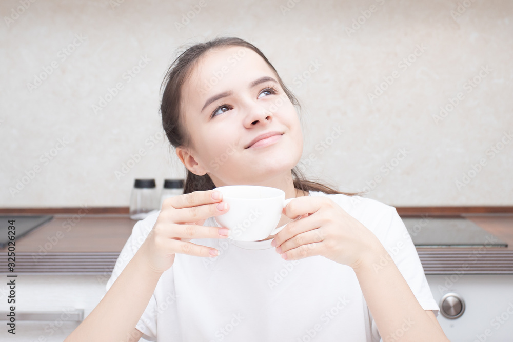 Beautiful european girl drinks aromatic coffee for breakfast Beautiful european girl drinks aromatic coffee for breakfast