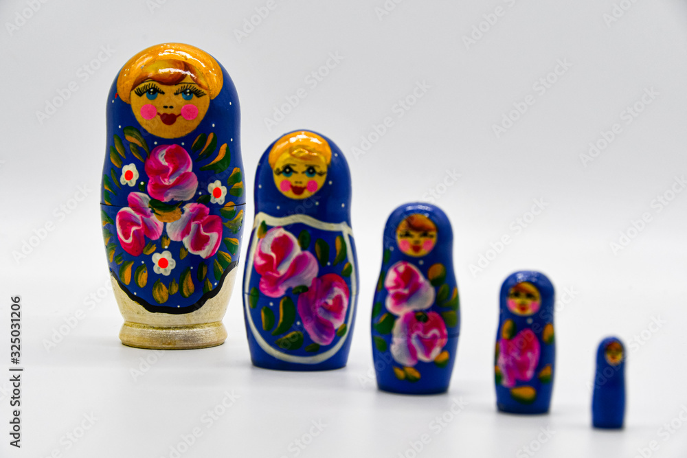 Classic Russian matryoshkas in row on put with white background Classic Russian matryoshkas in row on put with white background