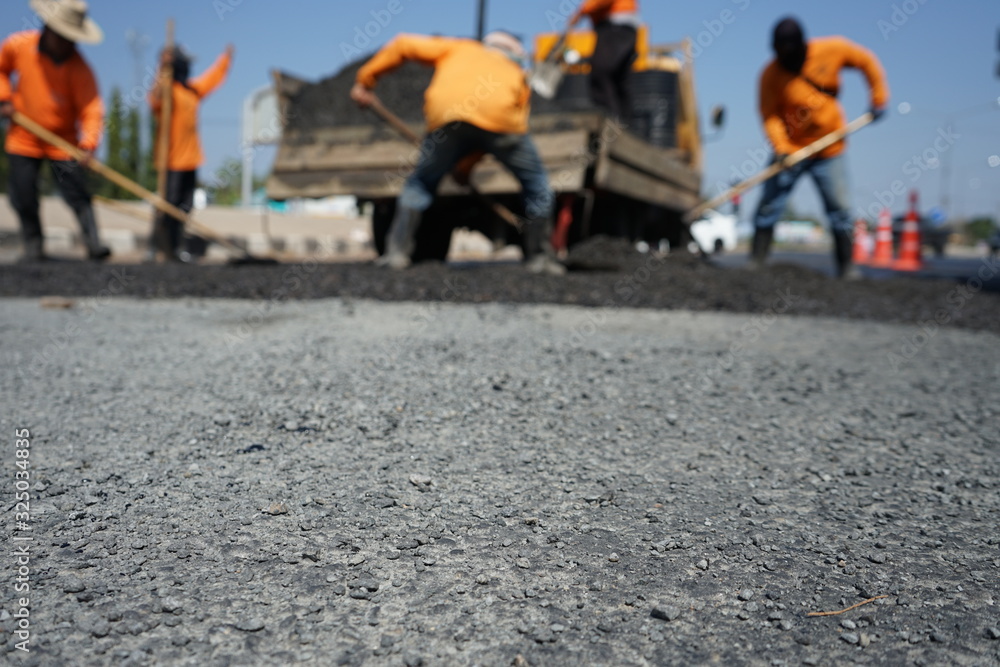 Blur image, repairing pavement mainly by manual labor Blur image, repairing pavement mainly by manual labor