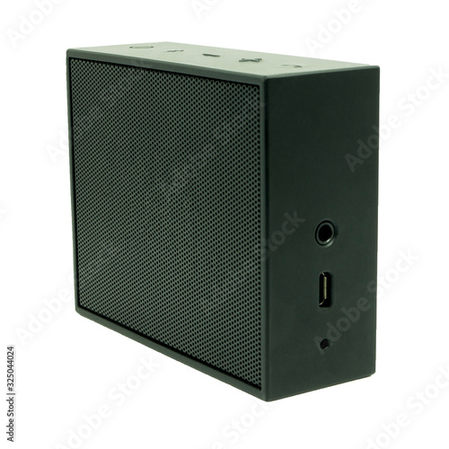 Side view of black wireless mini portable bluetooth speaker, show as the volume buttons and power connector on side, isolated on white background.