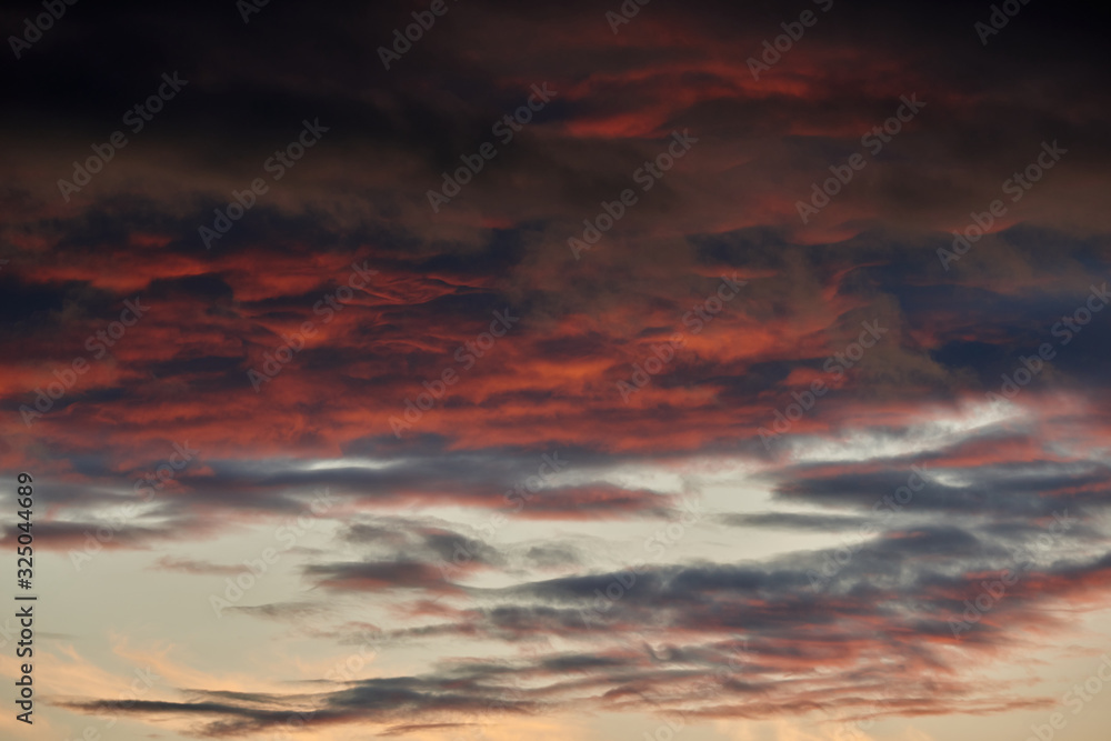 Naklejka premium beautiful dramatic sky with dark and bright clouds at sunset, summer landscape, golden sunlight
