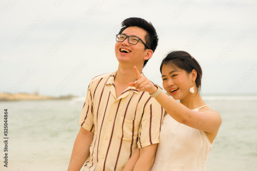 sweet and romantic lifestyle portrait of young happy Asian Korean couple in love enjoying holiday on beautiful beach walking together by the sea playful and affectionate sweet and romantic lifestyle portrait of young happy Asian Korean couple in love enjoying holiday on beautiful beach walking together by the sea playful and affectionate
