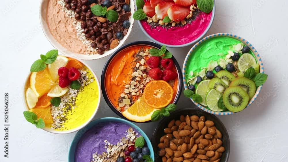 Various healthy fresh smoothies or yogurts in bowls. With strawberries, kiwi, chia, blackberries Various healthy fresh smoothies or yogurts in bowls. With strawberries, kiwi, chia, blackberries