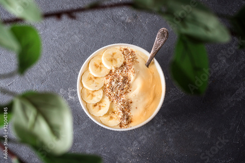 Healthy pineapple, mango smoothie bowl with banana and almond