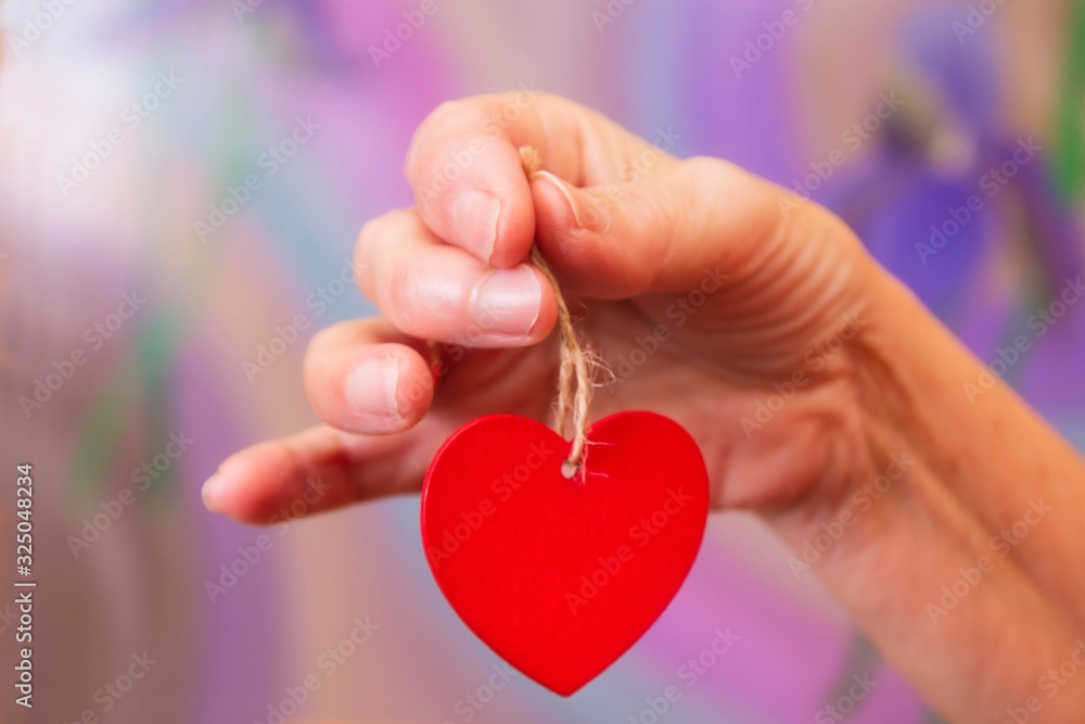 woman holding in her hand a red heart