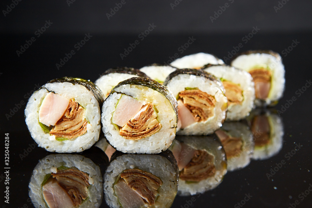 Traditional sushi roll with egg omelet and shred. Japanese food Traditional sushi roll with egg omelet and shred. Japanese food