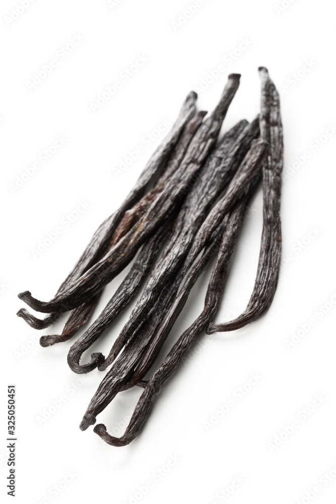 Bundle of dried bourbon vanilla beans or pods over white Bundle of dried bourbon vanilla beans or pods over white