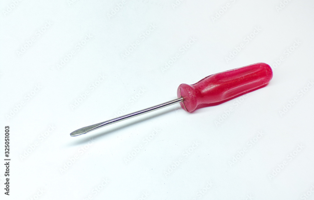 Isolated screwdriver on a white background. A small screwdriver for tightening screws and bolts. Isolated screwdriver on a white background. A small screwdriver for tightening screws and bolts.