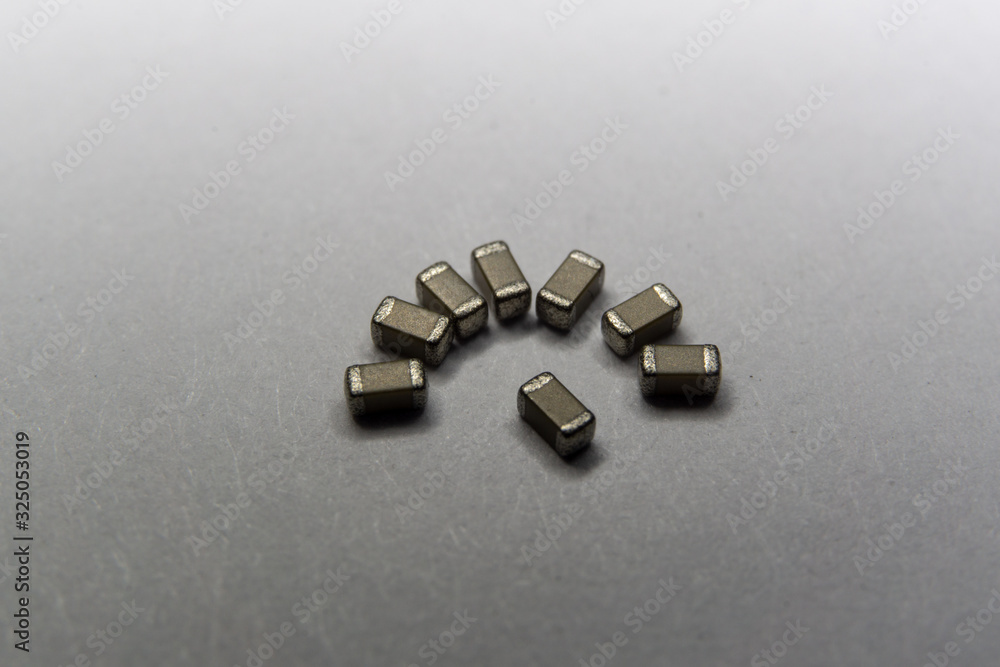 Abstract close-up of 0603 SMT surface mount MLCC capacitors electronics components in symbolic pattern Abstract close-up of 0603 SMT surface mount MLCC capacitors electronics components in symbolic pattern