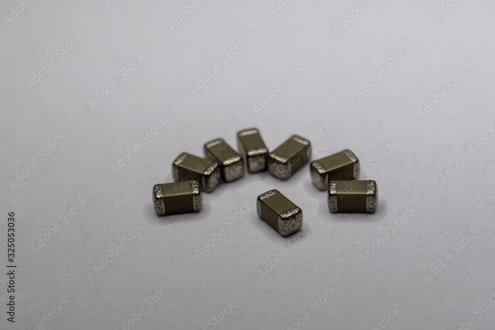Abstract close-up of 0603 SMT surface mount MLCC capacitors electronics components in symbolic pattern Abstract close-up of 0603 SMT surface mount MLCC capacitors electronics components in symbolic pattern