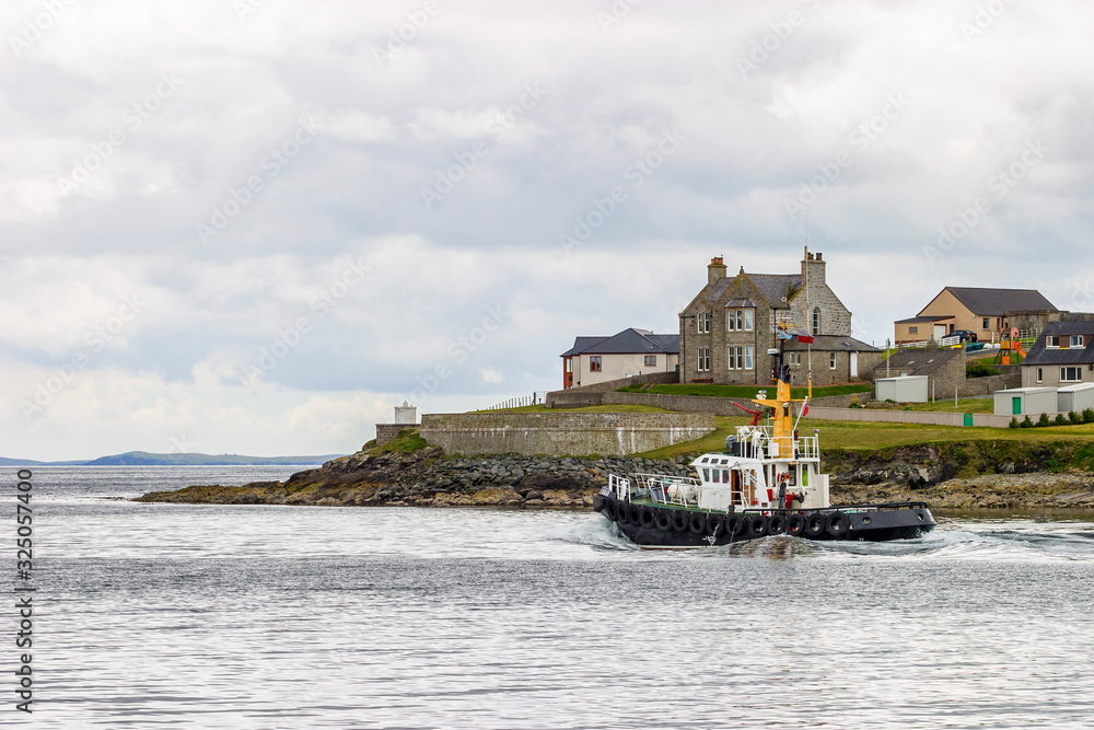 Tugboat on the way out to sea in Shetland