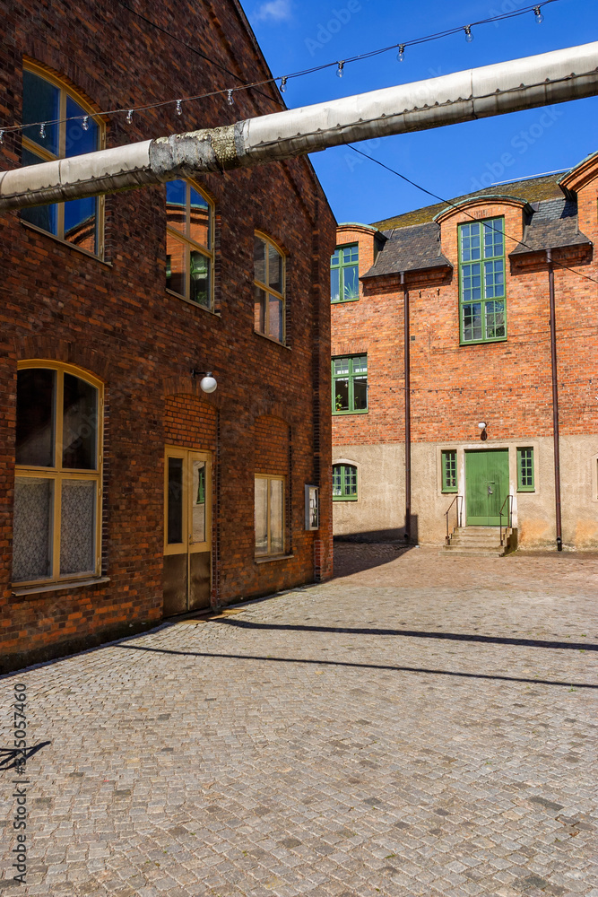 Courtyard at old industrial buildings made of brickstone
