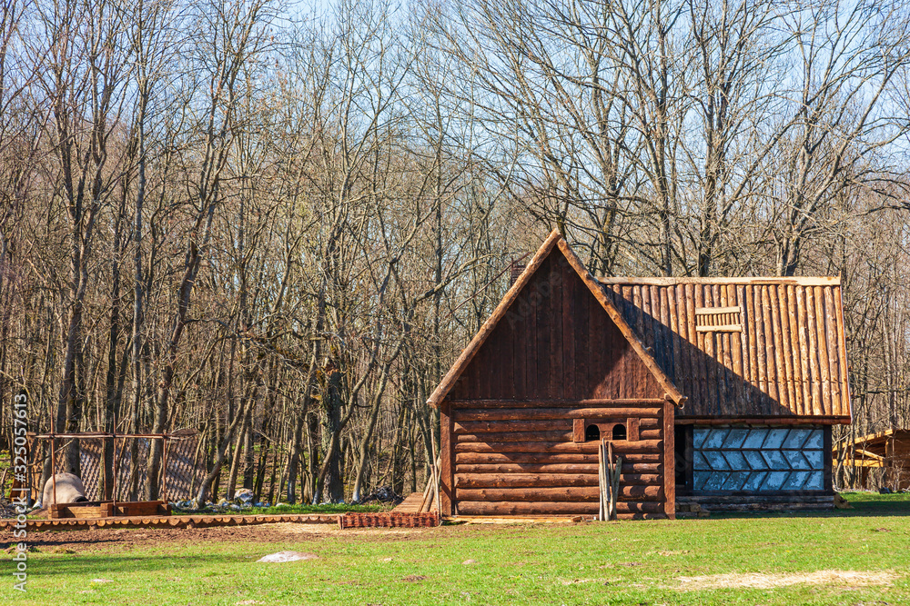 Log cabin on a meadow by a forest Log cabin on a meadow by a forest