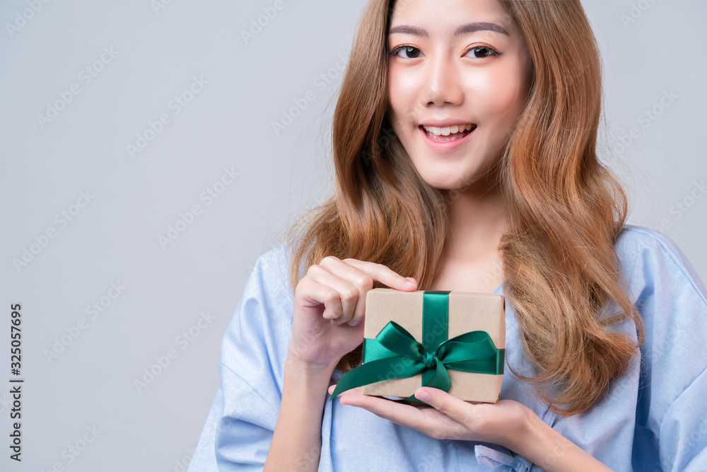 business healthy insurance beautiful asian female in hospital uniform smile with hand show credit card and present gift ideas for happy insurance package and promotion with hospital blur background business healthy insurance beautiful asian female in hospital uniform smile with hand show credit card and present gift ideas for happy insurance package and promotion with hospital blur background