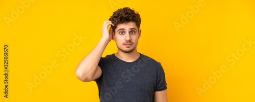 Young caucasian man isolated background with an expression of frustration and not understanding