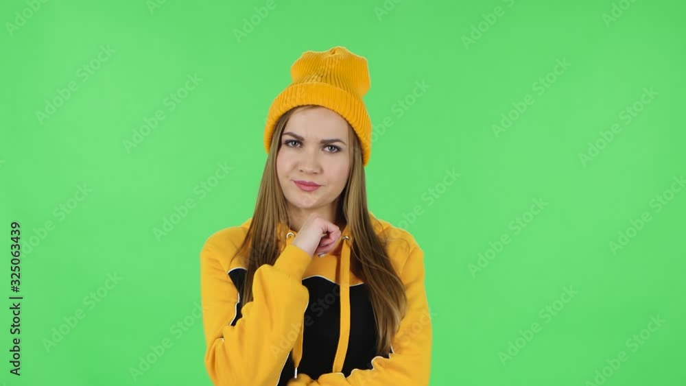 Portrait of modern girl in yellow hat is focused thinking about something, no idea. Green screen Portrait of modern girl in yellow hat is focused thinking about something, no idea. Green screen