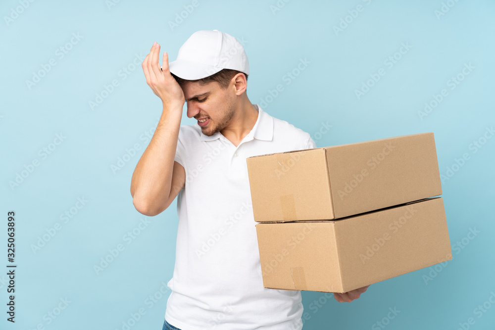 Delivery caucasian man isolated on blue background having doubts with confuse face expression Delivery caucasian man isolated on blue background having doubts with confuse face expression