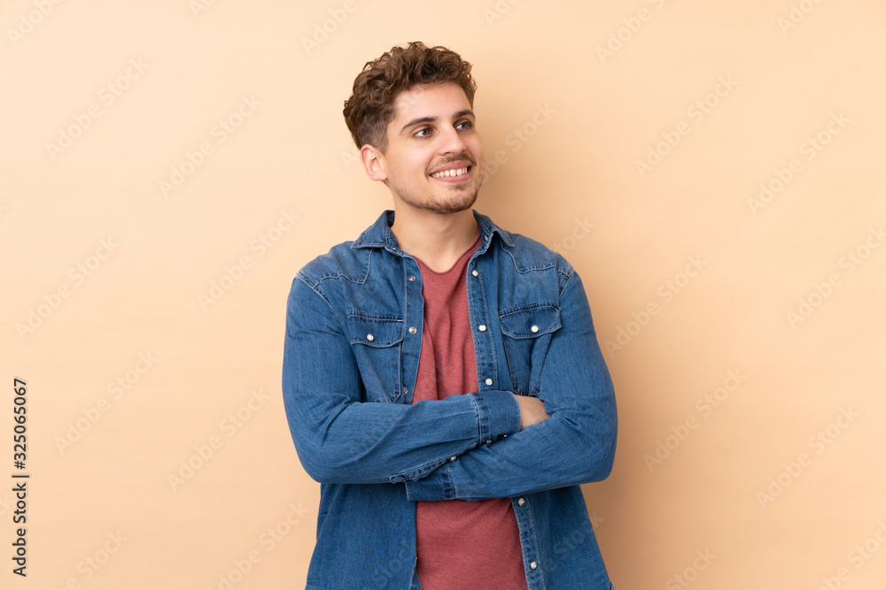 Caucasian man isolated on beige background looking to the side Caucasian man isolated on beige background looking to the side