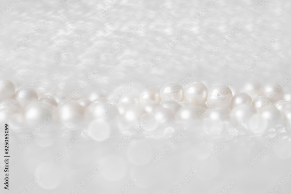 Nature white string of pearls on a sparkling background in soft focus, with highlights Nature white string of pearls on a sparkling background in soft focus, with highlights