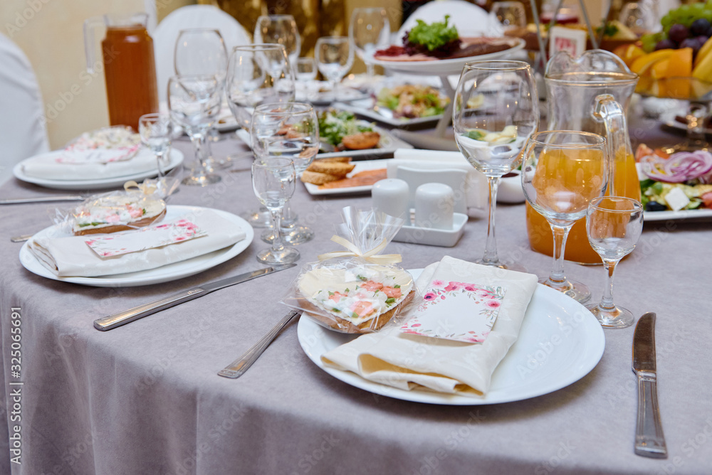 Table setting with sparkling wineglasses and cutlery on table, copy space. Menu mockup, place setting at wedding reception. Table served for wedding banquet in restaurant Table setting with sparkling wineglasses and cutlery on table, copy space. Menu mockup, place setting at wedding reception. Table served for wedding banquet in restaurant