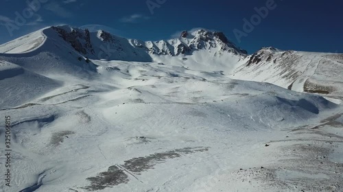 An extinct volcano Erciyas in Turkey. Mountain peak in the winter season. Snowboard base, ski resort. Beautiful snow covered the top of the mountain. photo