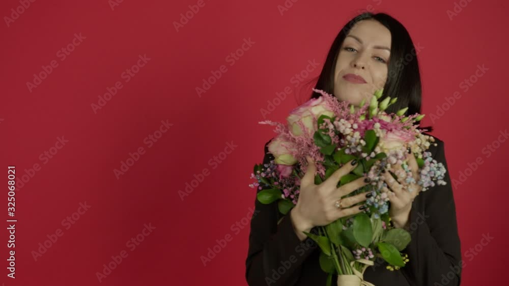 Skeptical woman with crossed arms refusing flowers and choosing eustoma bouquet with smile Skeptical woman with crossed arms refusing flowers and choosing eustoma bouquet with smile