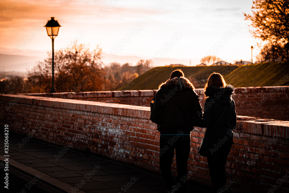 Fototapeta premium couple walking at sunset