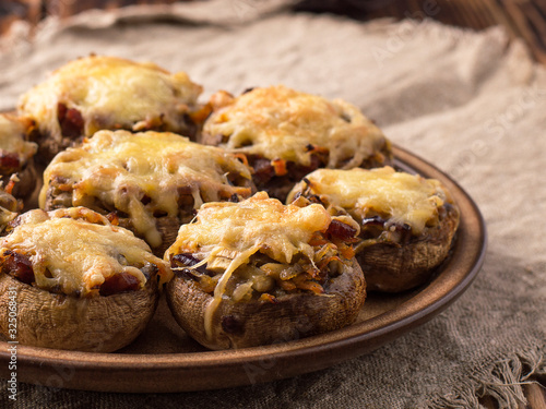Baked mushrooms in the oven with cheese and vegetables.