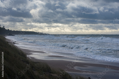 Fototapeta Naklejka Na Ścianę i Meble -  Landscape of stormy sea. Waves crashing on beach. Cloudy sky.