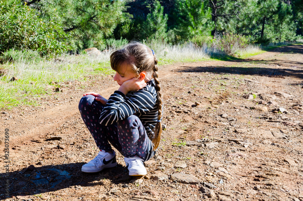 boredom in the forest, bored child on a walk on a forest road, girl has long hair bangs and striped shirt boredom in the forest, bored child on a walk on a forest road, girl has long hair bangs and striped shirt