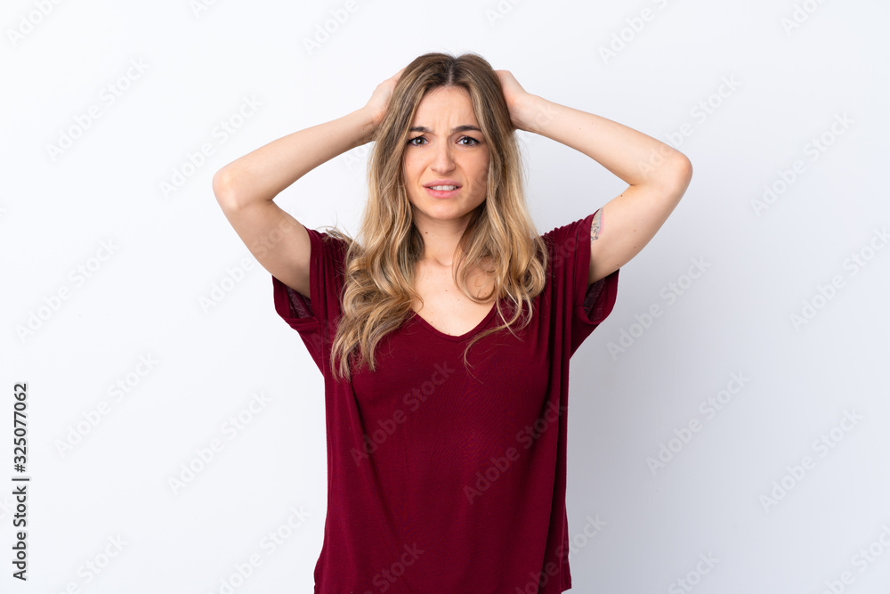 Young woman over isolated white background frustrated and takes hands on head Young woman over isolated white background frustrated and takes hands on head