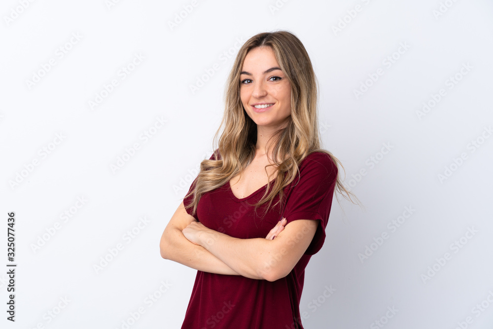 Young woman over isolated white background with arms crossed and looking forward Young woman over isolated white background with arms crossed and looking forward