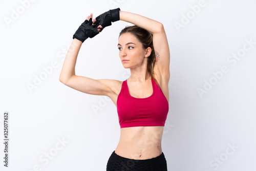 Young sport woman over isolated white background stretching © luismolinero