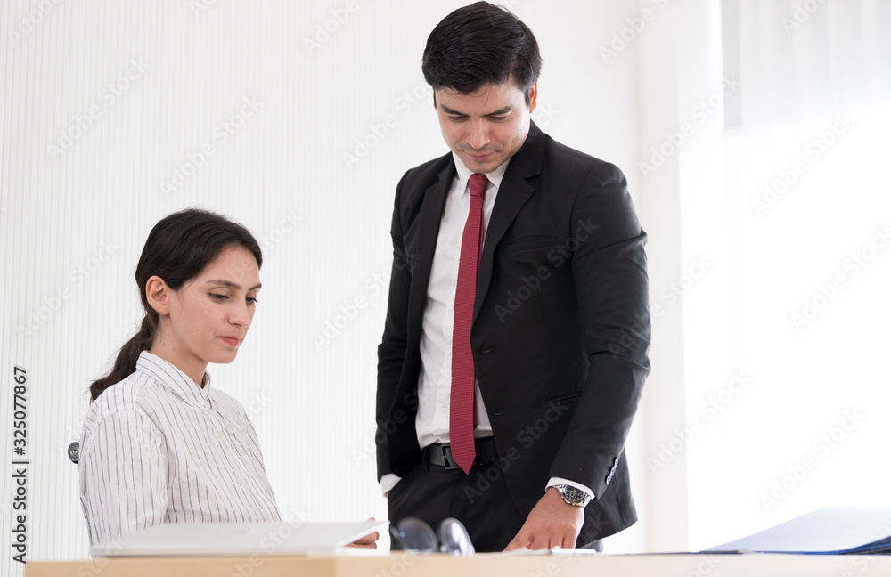 A manager and secretary working together in the office. A manager and secretary working together in the office.