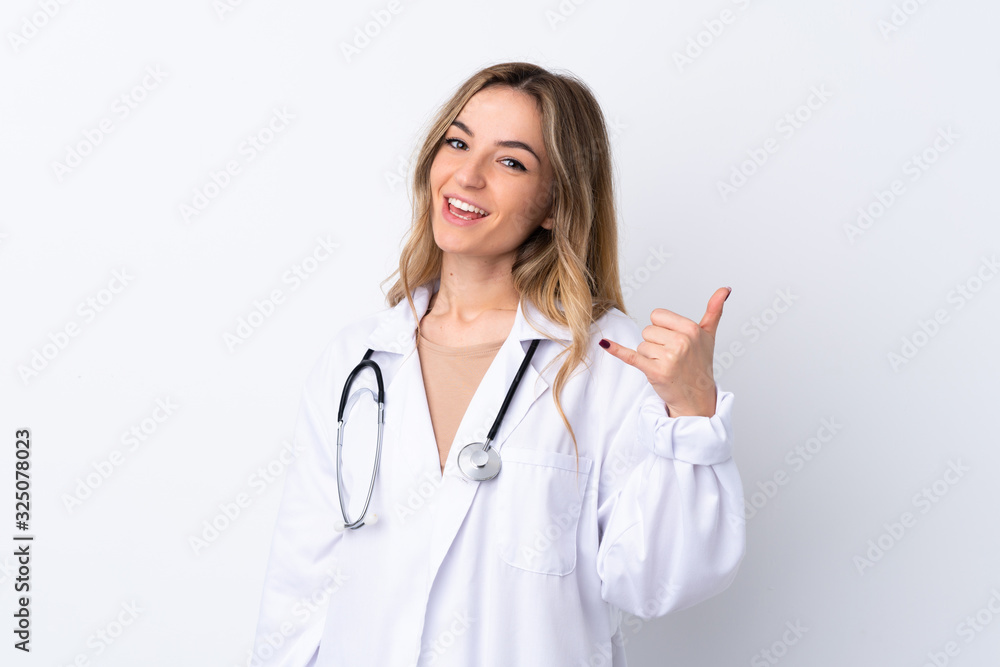 Young woman over isolated white background wearing a doctor gown and making phone gesture Young woman over isolated white background wearing a doctor gown and making phone gesture