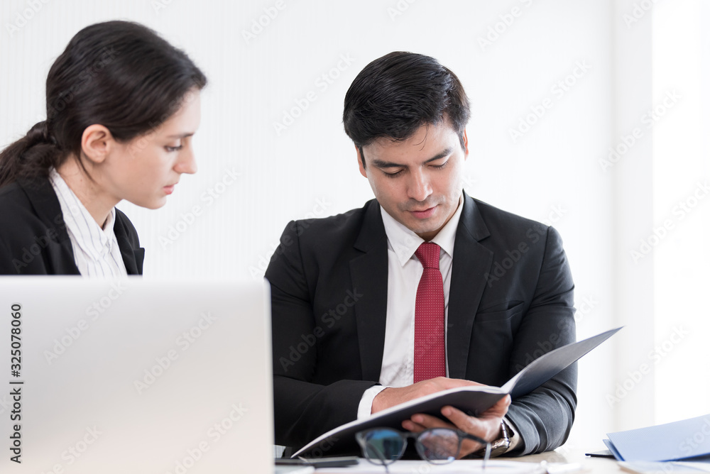 A manager and secretary working together in the office. A manager and secretary working together in the office.