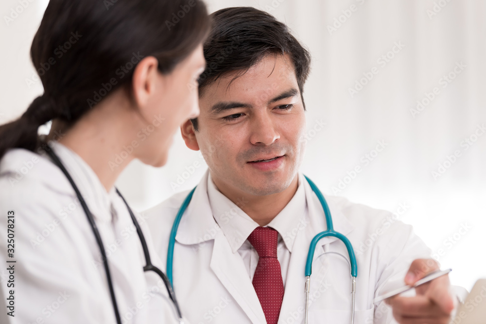 Two doctors have working together with happiness in the hospital. Two doctors have working together with happiness in the hospital.