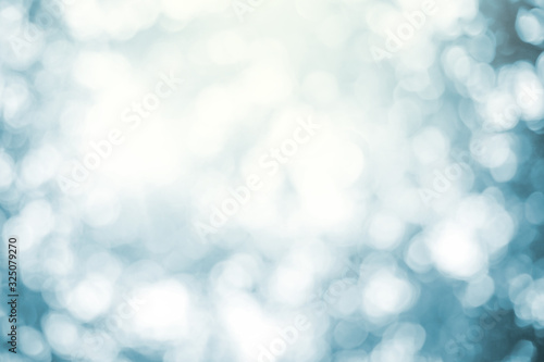 Light Blue Background Blurred leaves, circular bokeh, abstract from beautiful leaves, green nature concepts and for design images and computer screens. © Ping198