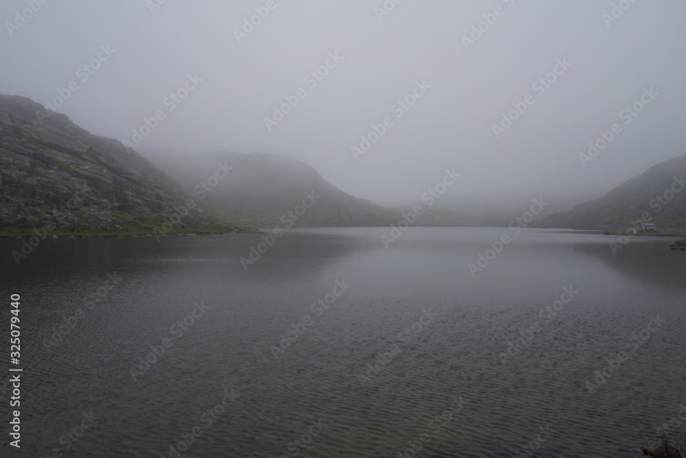 Fototapeta premium Foggy lake beyond the arctic circle in Summer
