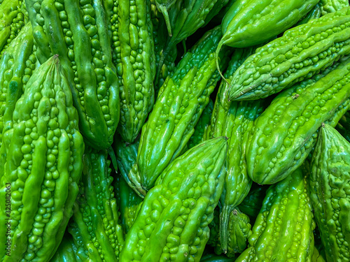 Full frame background photo of bitter melons at groceries store © Quang