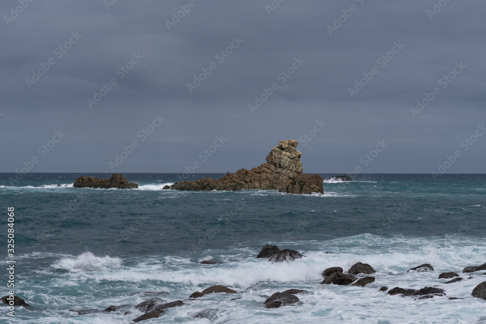 View to waves and Los Galiones cliff near Roque de Las Bodegas beach in the area of Taganana, Tenerife Island,  Spain