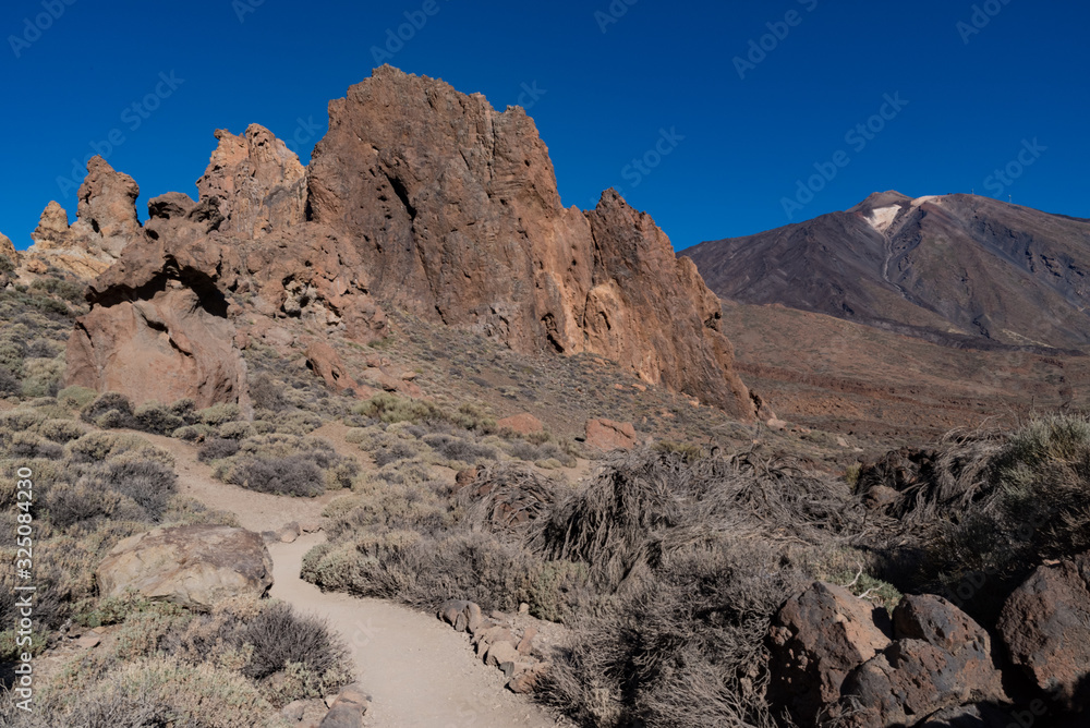 View of Roques de García unique rock formation with famous Pico del Teide mountain volcano summit in the background on a sunrise, Teide National Park, Tenerife, Canary Islands, Spain View of Roques de García unique rock formation with famous Pico del Teide mountain volcano summit in the background on a sunrise, Teide National Park, Tenerife, Canary Islands, Spain